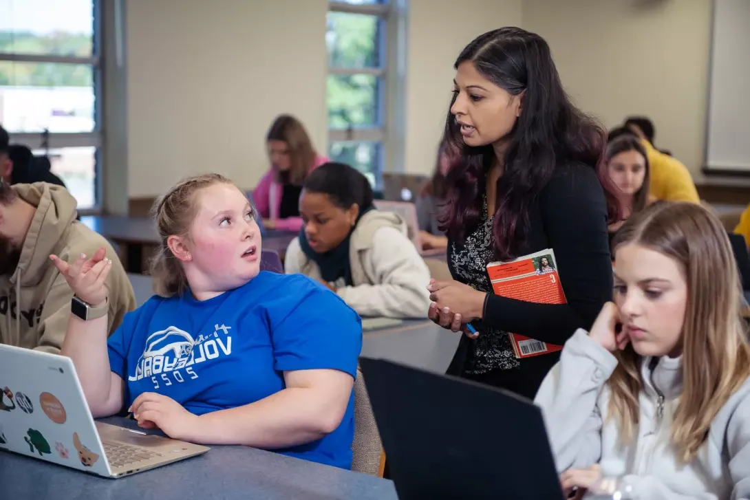 Student in African American literature class talking with instructor